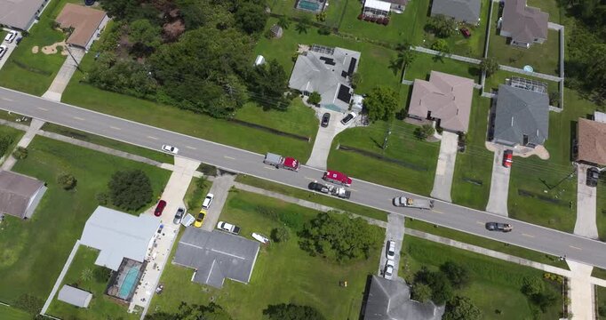 First responders provide medical assistance at private residence with ambulance and fire truck parked on street side.