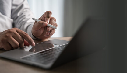 work from home office use the internet working on laptop computer sitting at office desk and working from home having work space