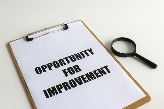 Opportunity For Improvement text on paper with magnifying glass as a financial, quality and compliance audit concept. Business management and strategy.