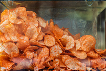 Close up on seasoned potato chips in a street vendor display case in Toluca, Mexico