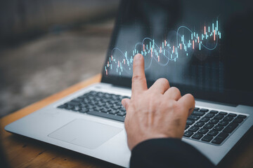 Businessman analyzing stock market data with digital candlestick chart, investment and opportunity concept, trading strategy, financial growth, business and enterprise analysis.
