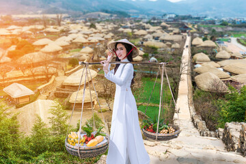 Tourists dressed in Vietnamese traditional clothing take photos in an ancient city in South Korea.
