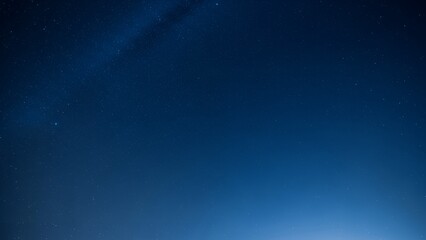 Obraz premium Clear Night Sky Filled with Sparkling Stars and Subtle Milky Way Galaxy Glow