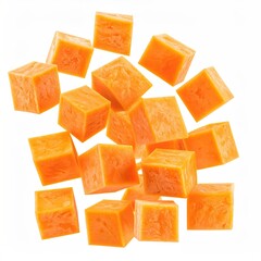 Orange cubed vegetables are scattered against a bright white background