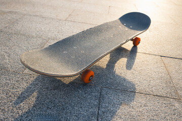 Skateboard outdoors in sunrise city