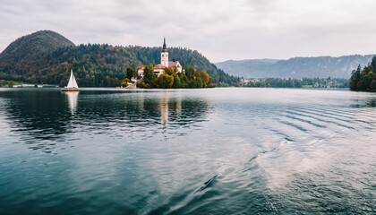 Scenic Lake Bled Island Church and Sailing Boat in Slovenia.