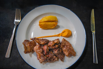 Traditional Spanish dish featuring succulent grilled lamb cutlets with sweet potato garnish, representing authentic cuisine along the Don Quixote Route.