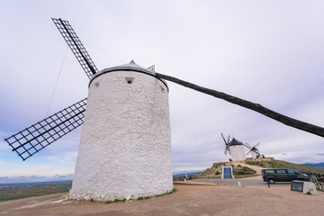 Traditional white windmills line the ridge in Consuegra, Spain, marking the famous site of the Don Quixote stories in La Mancha.