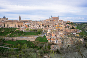 Panoramic view of Toledo, Spain during spring twilight. The ancient city sits on a hill surrounded by the Tagus River, creating a natural moat.