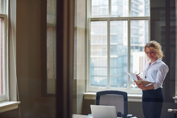 Woman, folder and project at office with documents, insight and glasses for proposal at insurance...