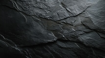 The surface shows a dark stone with various cracks and lines. The light enhances the texture. This stone could be part of a natural setting like a cave or mountain.