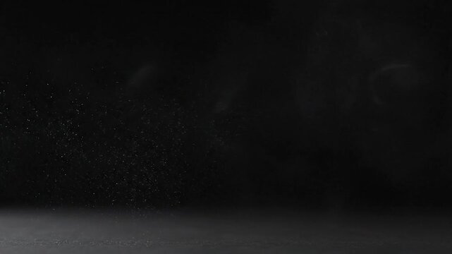 Abstract image features swirling smoke and particulate matter against a dark background