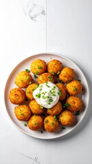 Golden potato puffs with cream & chives on a plate
