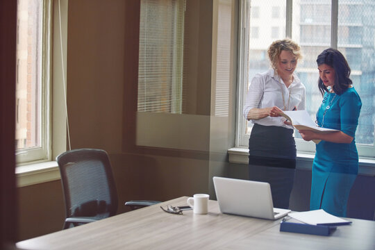 Business, women or meeting with paperwork in office for trial preparation, contract review or feedback. Law firm, paralegal and attorney with case file for legal research, evidence report and justice