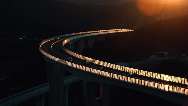 Črni Kal Viaduct in Slovenia during golden hour. Curved highway bridge glowing in sunset light, dramatic shadows, modern infrastructure cutting through a mountainous landscape.