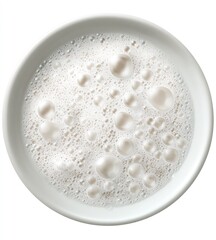 Foamy white liquid in a round, clean white bowl from above