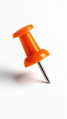 Close-up of an orange push pin casting a shadow