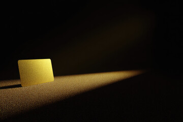 Gold scratch off card stands upright on textured surface illuminated by dramatic light creating sense of anticipation and excitement in dark background