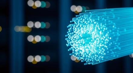 Close up of bright blue fiber optic cable bundle with light streaming through for high speed internet connection and data transfer.