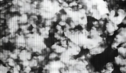 Abstract grayscale image of textured spots and grids