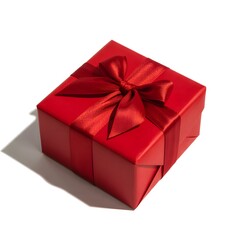 Obraz premium A beautifully wrapped red gift box with a vibrant satin ribbon bow presented solo