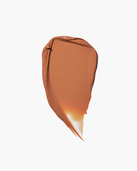 Warm brown cosmetic foundation smear on white background