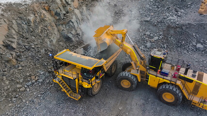 rock extraction and loading process in an open-pit mine using heavy machinery