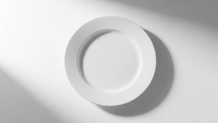 Minimalist empty white plate on a bright white background with soft, abstract light and shadow patterns, perfect for copy space or mockups.