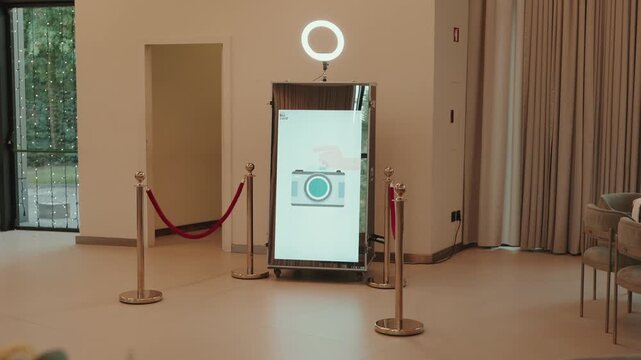 Interactive mirror photo booth with ring light at wedding reception