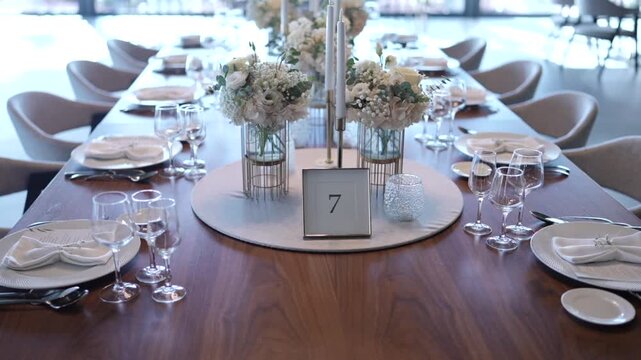 Elegant wedding dining table setup with flowers candles and tableware