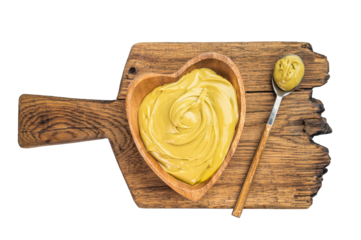 Sweet pistachio cream spread with rich green color served in wooden bowl minimal dessert concept on white background