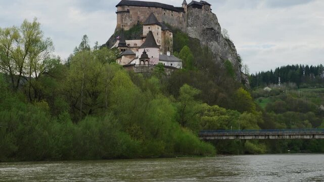 Tilt up shot from the Orava river to the castle, Slovakia