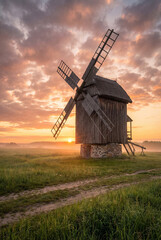Naklejka premium Old Rustic Windmill in Countryside Landscape, Traditional Rural Heritage