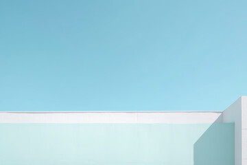 Bright blue sky with a light wall at a modern building during daytime with soft shadows and clear weather