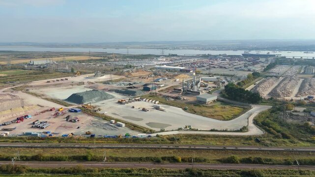 Drone Footage of Busy Industrial Port Showing Fuel Silos, Cargo Containers and Maritime Import Export Operations on Thames at Dartford UK