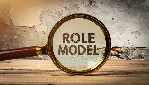 Magnifying glass over &ldquo;ROLE MODEL&rdquo; on rustic wood