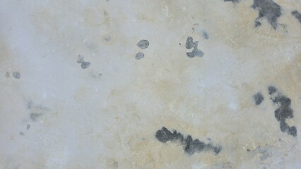 An old and aged concrete floor surface. It features visible signs of damage, peeling paint, water stains, and dark mold marks. The rough, grunge texture is ideal for vintage design backgrounds.