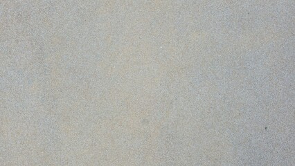 Concrete floor mixed with gray and beige gravel, road texture, walkway texture, small gravel road surface, tactile surface, and background.