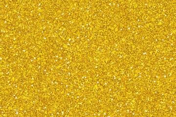 Shimmering surface of dense, sparkly golden glitter texture fills the frame