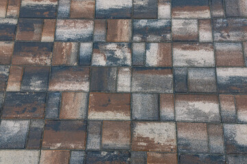 Paving slabs for paths. Paving slabs made of cement mix. Paving stones made of artificial materials. Laying tiles on the road. Material for covering sidewalks and streets. Repair of sidewalks