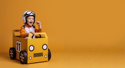 Happy child playing in homemade cardboard race car. Excited boy in driver's helmet pretending to win. Childhood imagination and creative play concept with copy space