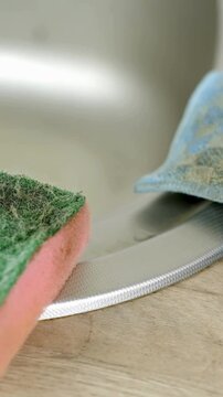 Close up of used sponge rag in the kitchen at home equipment for the household cleaning at home dirt on the surface vertical.