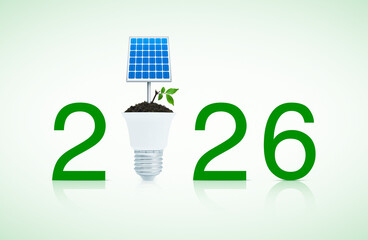 2026 text with solar cell and fresh green tree leaves on soil with led light bulb on white background, Happy new year 2026 green ecology and saving energy concept