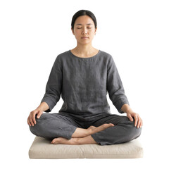 Young Woman Meditating in a Serene Setting on a Soft Cushion in Neutral Tones