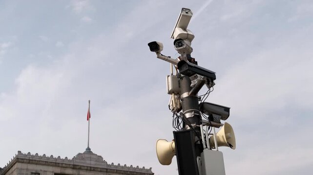 Security and public monitoring in Shanghai. Utility pole equipped with multiple surveillance cameras and loud speakers.