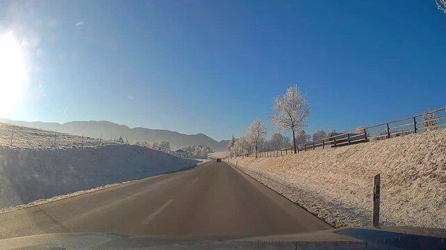 Straight Winter Road Drive Surrounded by Snowy Fields