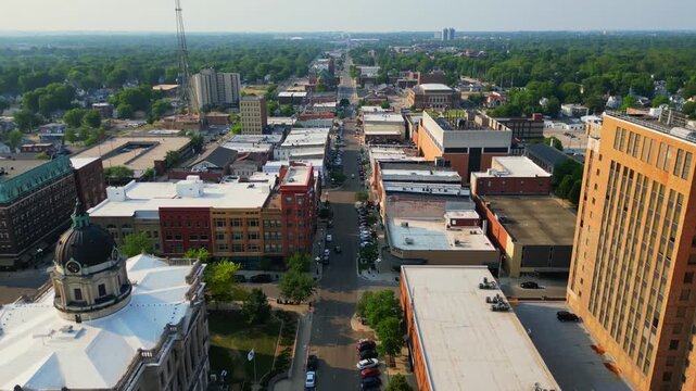 An impressive aerial view captures the vibrant downtown of Bloomington, Illinois, showcasing the historic McLean County Courthouse with its distinctive dome