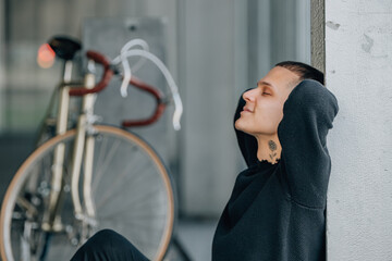 young man with a bicycle on a city street