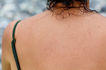 A woman with wet hair and a green shirt