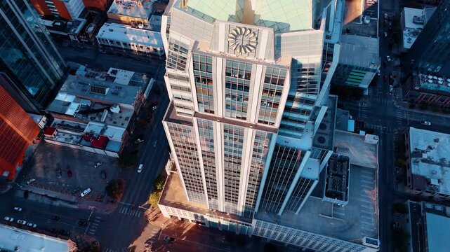 Approaching the facade of the outstanding Frost Bank Tower in Austin, Texas, USA. Drone flight above the city at daytime.